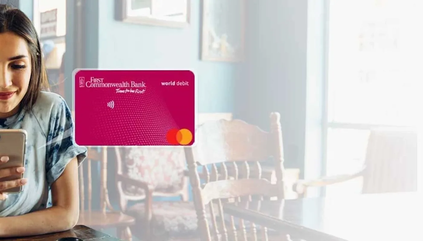 Payment card displayed beside a mobile device